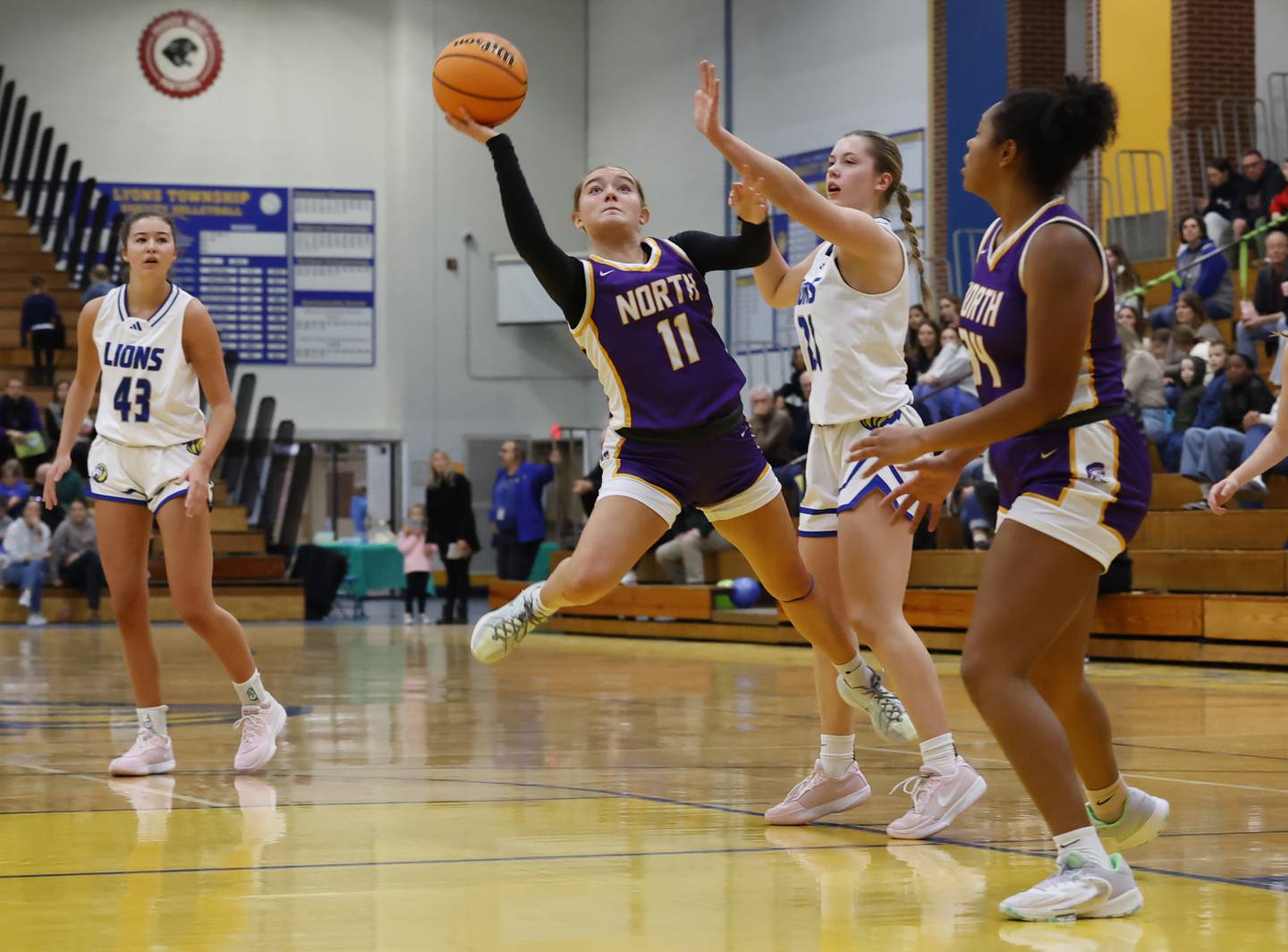 Downers Grove North's Abigail Gross (11) puts up a shot during the girls varsity basketball game between Downers Grove North and Lyons Township on Saturday, Jan. 11, 2025 in La Grange.
