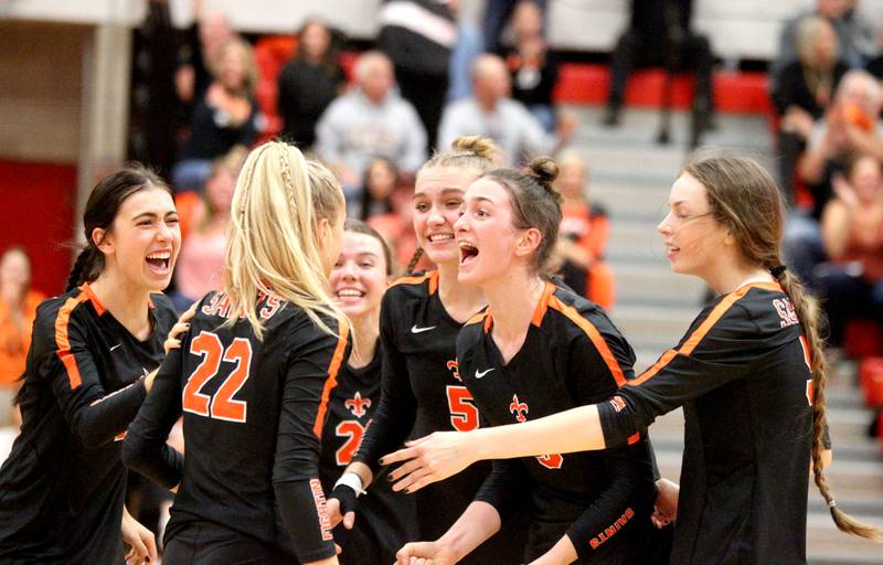 St. Charles East players celebrate a point during a Class 4A Hinsdale Central supersectional against Loyola Academy on Friday, Nov. 4, 2022. St. Charles East won 25-22, 25-18.