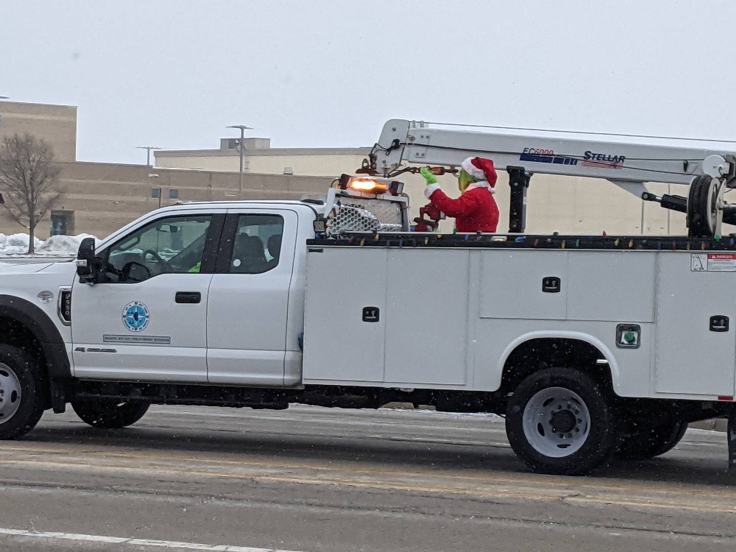 The Grinch waves to those watching the Santa Send-Off Parade as it travels past Plainfield South High School on Saturday, Dec. 13, 2025.