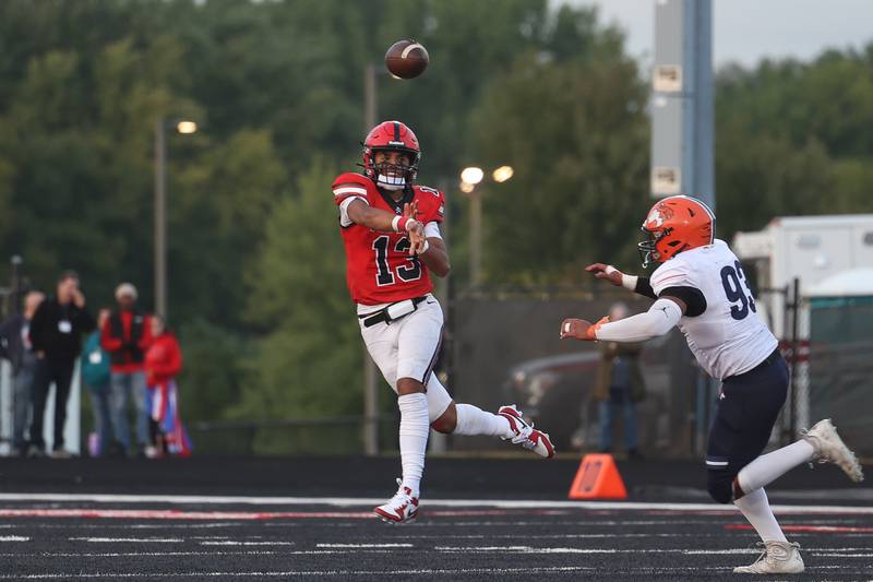 Bolingbrook’s Jonas Williams passes on the run against Naperville North on Friday, Sept. 8, 2023 in Bolingbrook.