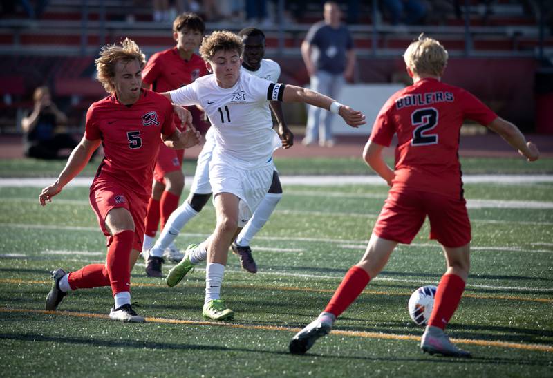 Minooka's Jamie Franson, center, looks to regain control of the ball as Bradley-Bourbonnais' Brayden Watters, left, and Trenton Ward, right, defend in a game on Tuesday, August 26, 2025.