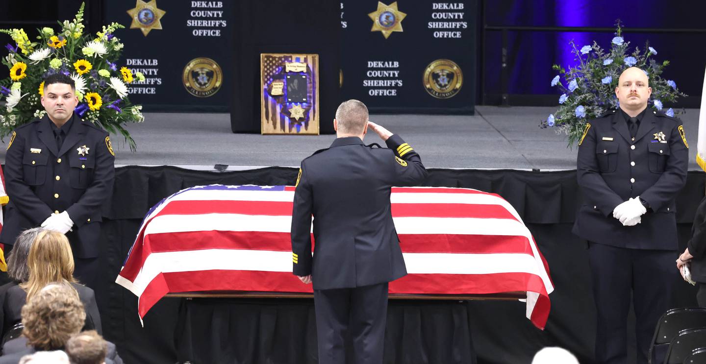 DeKalb County Sheriff Andy Sullivan salutes the flag-draped casket of colleague Deputy Christina Musil Thursday, April 4, 2024, during her visitation and funeral in the Convocation Center at Northern Illinois University. Musil, 35, was killed March 28 while on duty after a truck rear-ended her police vehicle in Waterman.