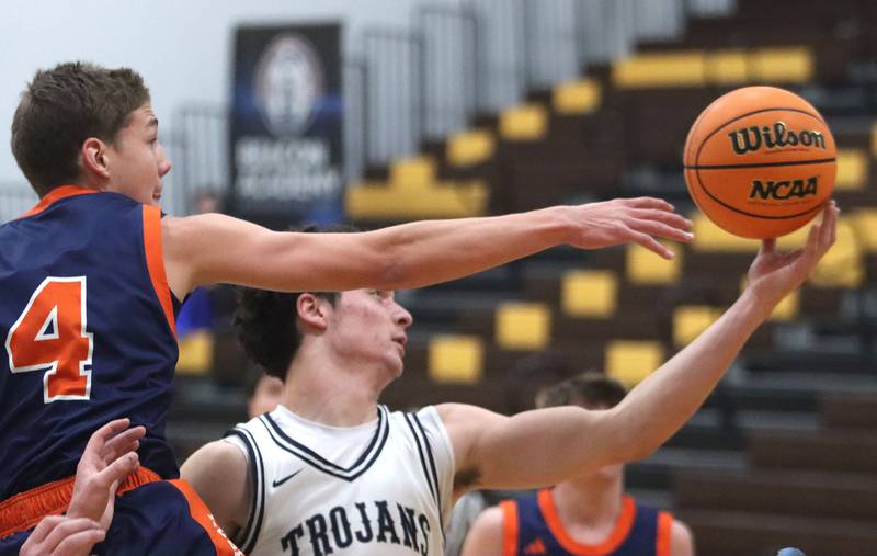 Cary-Grove’s Adam Bauer, right, battles Naperville North’s Miles Okyne in varsity boys basketball Hinkle Holiday Classic action on Monday, Dec. 21, 2025, at Jacobs High School in Algonquin.