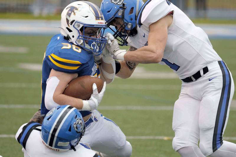 Brian Hill/bhill@dailyherald.com
Wheaton North's Kyle Both (36) is brought down by Lake Zurich's Michael Boenzi (1) and Coplan Oettinger (4) during the second round of the IHSA playoffs Saturday November 5, 2022 in Wheaton.
