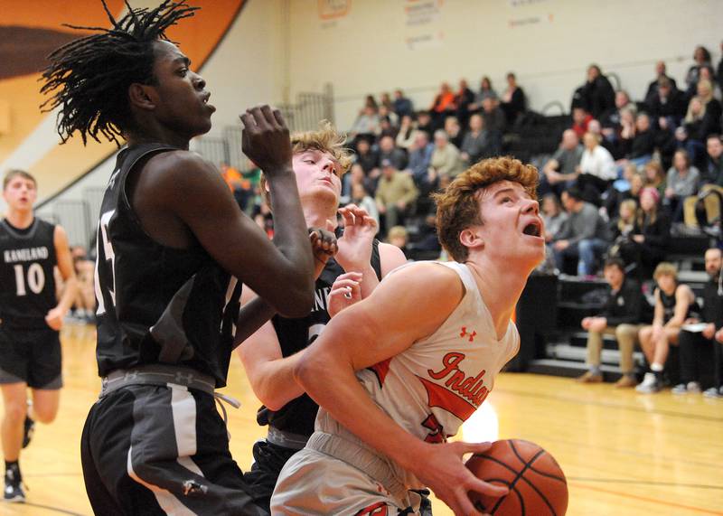Sandwich's Dom Rome looks for a tough shot against two Kaneland defenders during a boys' basketball game at Sandwich High School on Friday, Jan. 13, 2023.