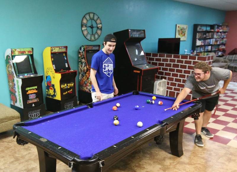 Bradyn Briddick, and Dominic Schillaci shoot a game of pool at the current Second Story Teen Center above Johnson's Carpet on Wednesday, Aug. 16, 2023 in Princeton.