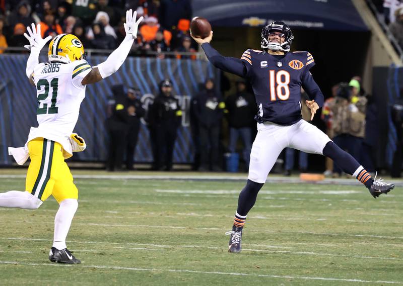 Chicago Bears quarterback Caleb Williams throws on the run over Green Bay Packers cornerback Nate Hobbs Saturday, December 20, 2025, during their game at Soldier Field in Chicago.