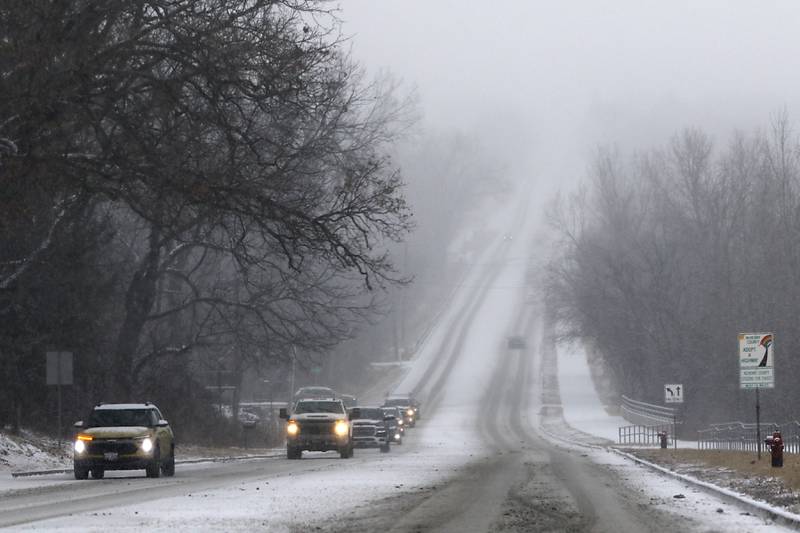 Traffic navigates the hill on Walkup Road on Wednesday, Feb. 12, 2025, in Crystal Lake as a winter storm starts to bring heavy snow to the McHenry County area