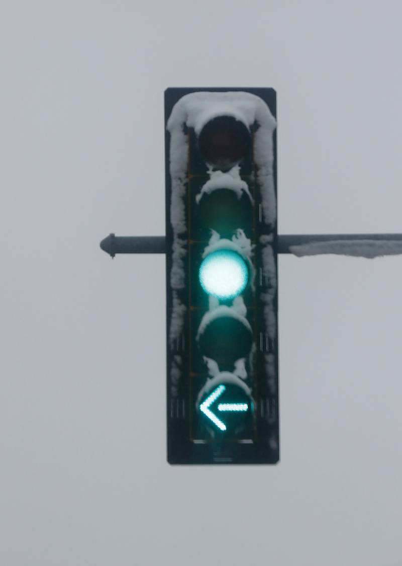 Snow on a traffic single at the intersection of U.S. 12 and Illinois 173  on Friday,  Dec. 9, 2022, in Richmond. Areas of McHenry County received a couple of inches on snow after a winter storm moved through the county.