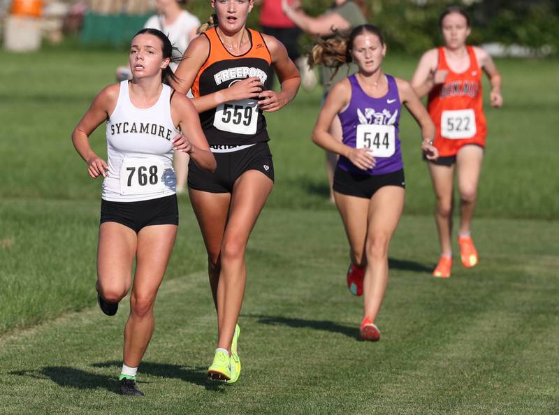 Sycamore’s Layla Janisch moves ahead of a group in the varsity race Tuesday, Sept. 2, 2025, during the Sycamore Cross Country Invitational at Northern Illinois University in DeKalb.