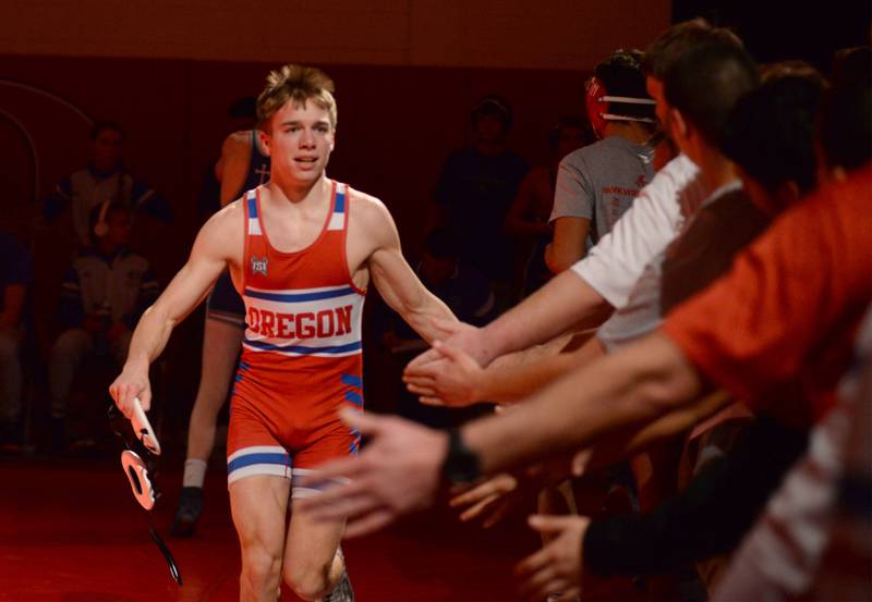 Oregon's Jackson Messenger is congratulated by his teammates after winning his 138-pound match against Sterling Newman's Jason Curtin at the 1A team sectional held Tuesday, Feb. 25, 2025 in the Blackhawk Center in Oregon.