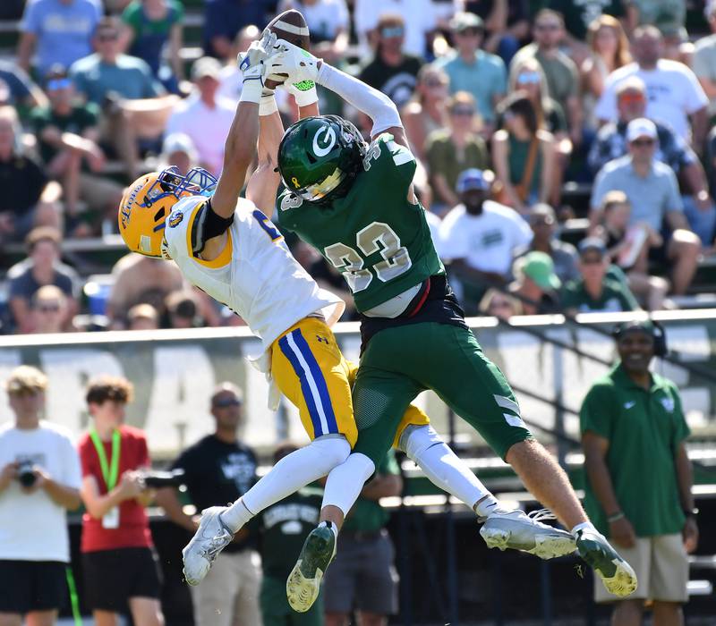 Glenbard West’s MJ Wargin (33) intercepts a pass intended for Lyons Township’s Sam Froelich during a game on September 27, 2025 at Glenbard West High School in Glen Ellyn.