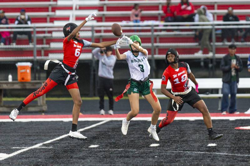 Plainfield Central's Delaney Weber (3) breaks up a pass attempt to Bolingbrook's Kennedy Williams (6) during flag football game between Plainfield Central at Bolingbrook Wednesday, Sept 3, 2025  in Bolingbrook.