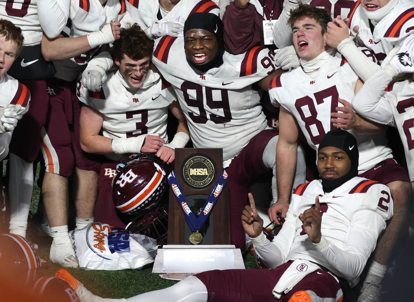 Brother Rice players celebrate sith the trophy Wednesday, Dec. 3, 2025, after their IHSA Class 7A state chamionship win over St. Rita in Huskie Stadium at Northern Illinois University in DeKalb.