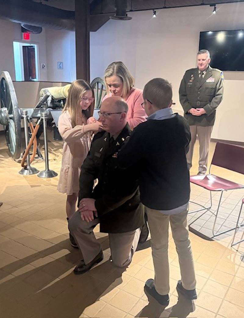 Dr. Timothy J. Williams’ son Carter, daughter Sadie and wife Tiffani pin Colonel rank on his uniform during a promotion ceremony Jan. 4 at the Illinois State Military Museum at Camp Lincoln.