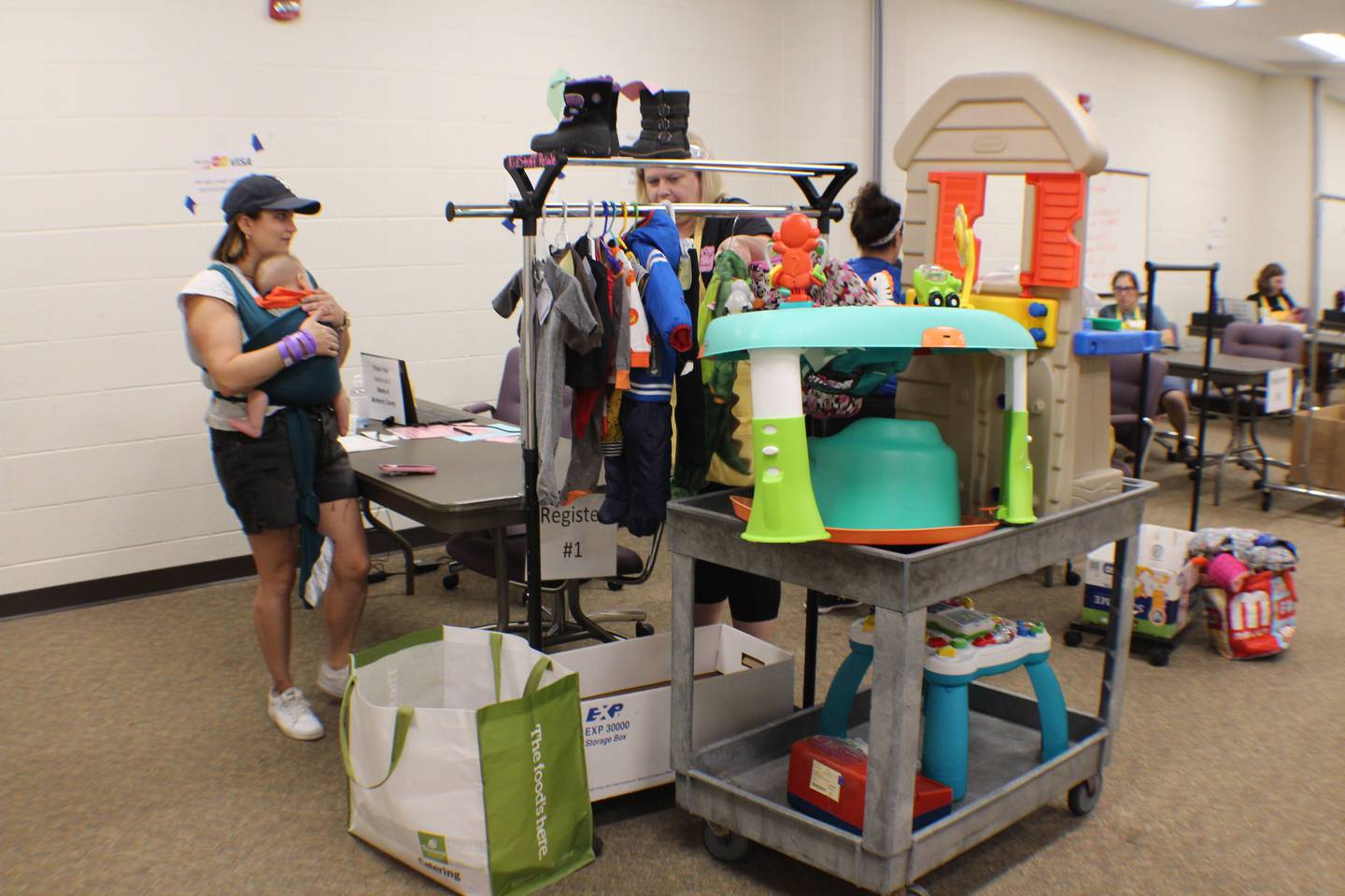 A mom with her purchases at the August 2025 KidsStuff Resale, put on since 1998 by the Moms of McHenry County.