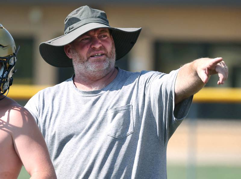 Hiawatha football head coach Kenny McPeek instructs his team during practice Wednesday, Aug. 14, 2024, at the school in Kirkland.