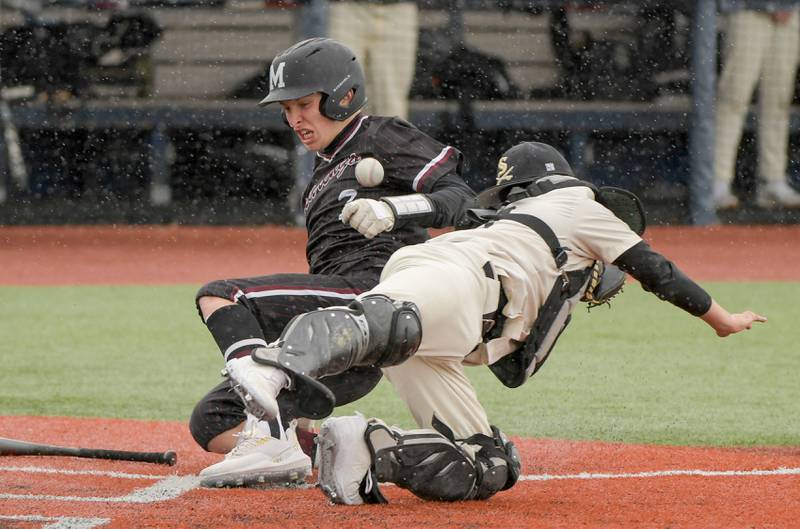 Marengo's Sam Chaffin (7) slides safely into home on an over throw to Streamwood's Miguel Rodriguez (10) during a game on Monday, March 25, 2024 in Carol Stream.