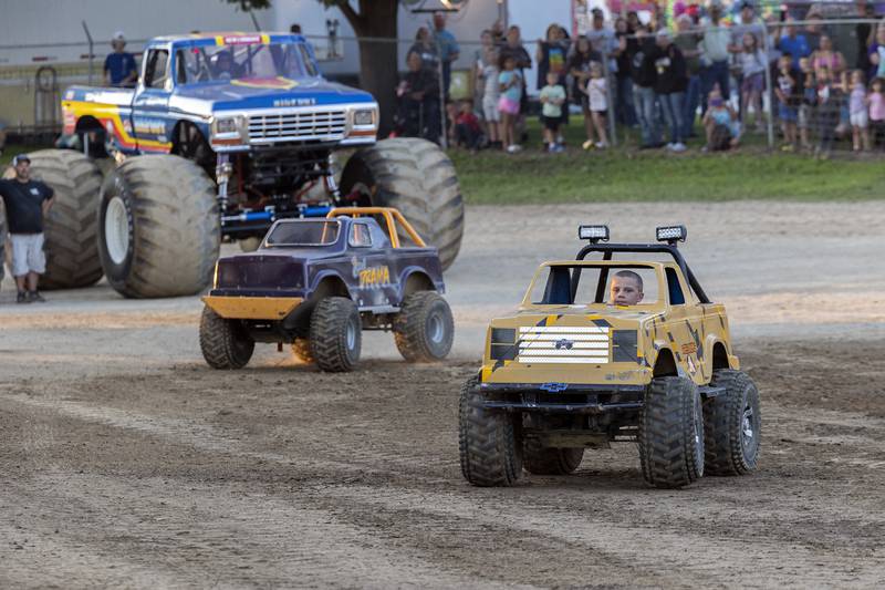 Chance Williams (left), 11, drives Girl Drama and Beau Brackemyer, 10, both of Morrison races Wrecking Ball, in the mini monster truck  event Thursday, August 17, 2023 at the Whiteside County Fair.