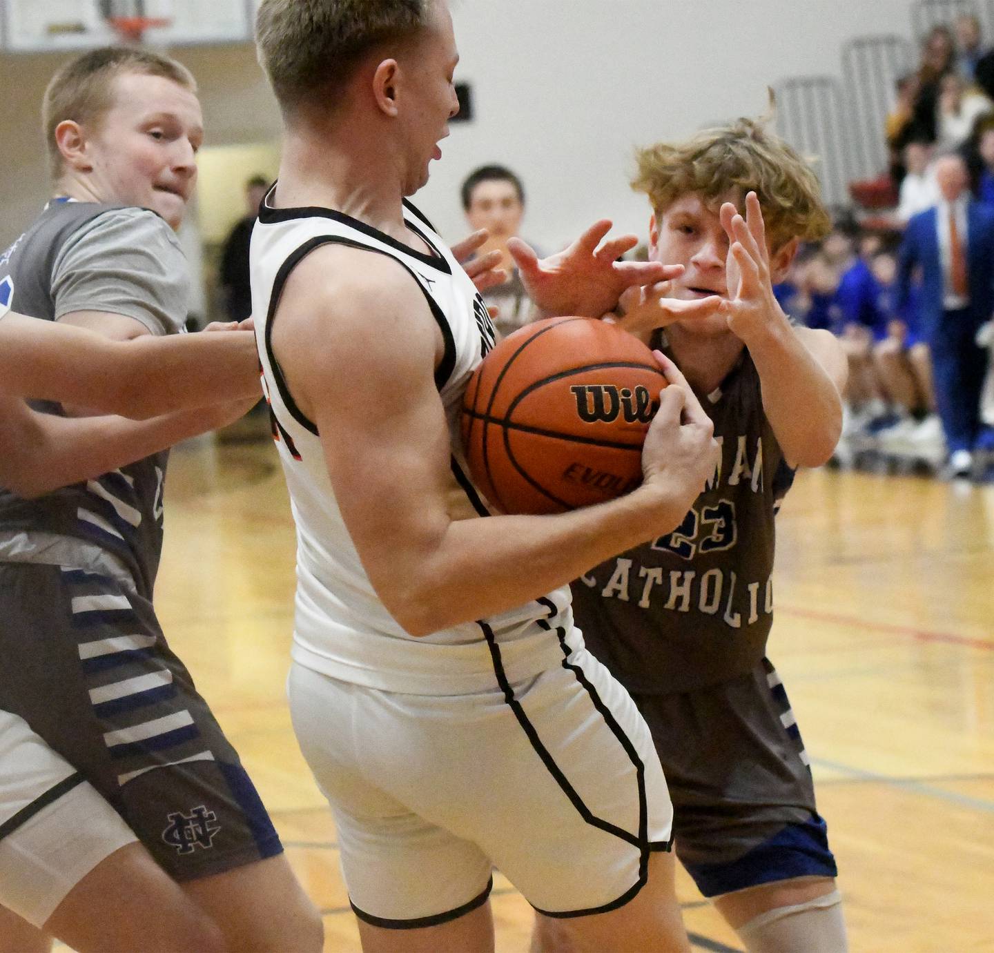 Newman's Lucas Simpson reaches for the ball as Byron's Braylon Kilduff wraps it up in the championship game at the 62nd Forreston Holiday Tournament on Thursday, Dec. 21, 2023.