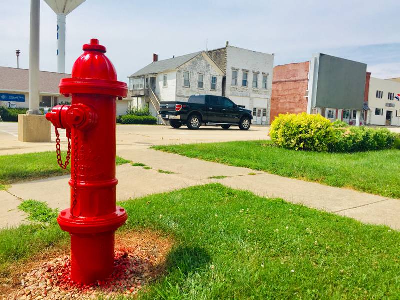 A pickup truck passes one of the village of Ohio’s fire hydrants at the corner of Main and Jackson streets Tuesday. Hydrants throughout town recently received a fresh coat of red paint.