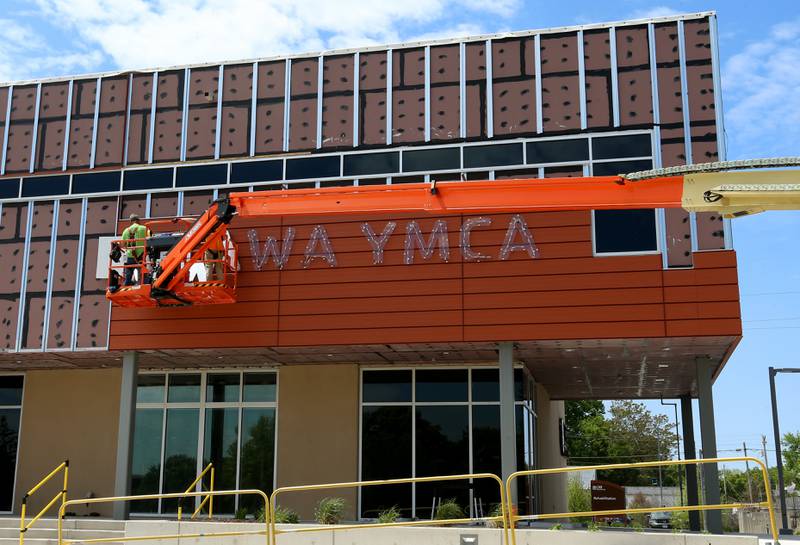 Crews install letters spelling "Ottawa YMCA" on Monday, May 6, 2024 at the new YMCA in Ottawa.