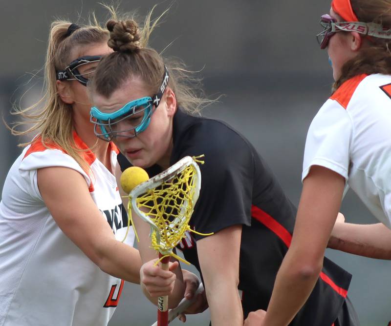 Huntley’s Aubrie Rohrbacher tries to corral the ball  in varsity girls lacrosse on Friday, April 18, 2025, at Metcalf Field on the campus of Crystal Lake Central High School in Crystal Lake.