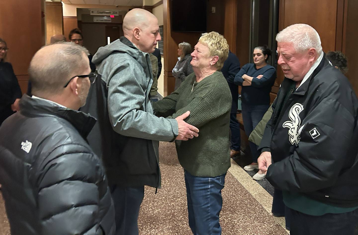Retired Ogle County Sheriff's Detective Brian Ketter (center) and Detective Chad Gallick (left) greet Don and Luann Rosko of Mt. Morris on Thursday, Jan. 29, 2026 outside the courtroom where jurors found Duane "DC" Meyer guilty of murdering Maggie Rosko Meyer, 31, and her son, Amos, 3, in 2016.