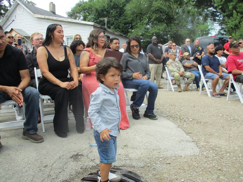 Jose Duenez III watches as officials gather to speak in honor of his late father, Jose Duenez Jr., at a street dedication ceremony in Joliet on Friday, July 11, 2025.