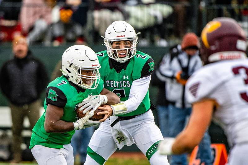 Providences Lucas Proudfoot hands the ball off to Jamari Tribett during the 3rd round IHSA Class 4a  playoff game against Richmond-Burton Saturday Nov. 12, 2022 at Providence Catholic High School in New Lenox