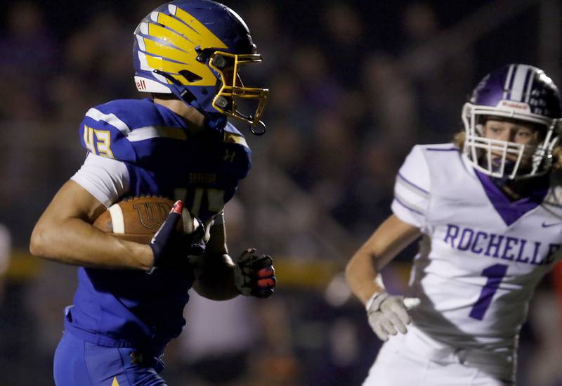Johnsburg's Braden Olson runs to the end zone to score a touchdown as he is chased by Rochelle's Grant Gensler during a IHSA Class 4A second round playoff football game Friday, Nov. 4, 2022, between Johnsburg and Rochelle at Johnsburg High School in Johnsburg.