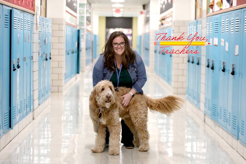Albright Middle School Principal Dr. Gerrie Aulisa stands in the hall with her dog, Benny, who serves as the school’s trained therapy dog. Aulisa, who is also the director of technology at the Villa Park School, is one of six Golden Apple finalists throughout Illinois.