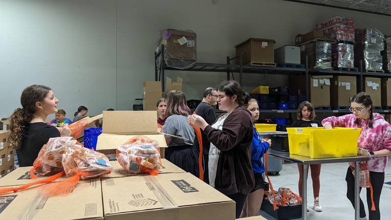 Students from Minooka Junior High School repack food for people in need at the Northern Illinois Food Bank South Suburban Center in Joliet on Thursday, April 27, 2023.