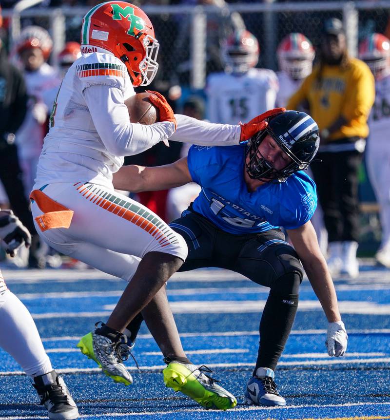 Morgan Park's Keshawn Lewis-Hunt (24) carries the ball and stiff arms St. Francis' Liam Kolinski (14) during a class 5A state quarterfinal football game at St. Francis High School in Wheaton on Saturday, Nov 11, 2023.