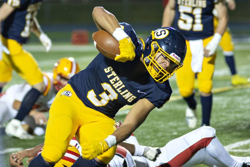 Sterling’s Antonio Tablante fight for the goal line Rock Island Friday, Oct.7, 2022.
