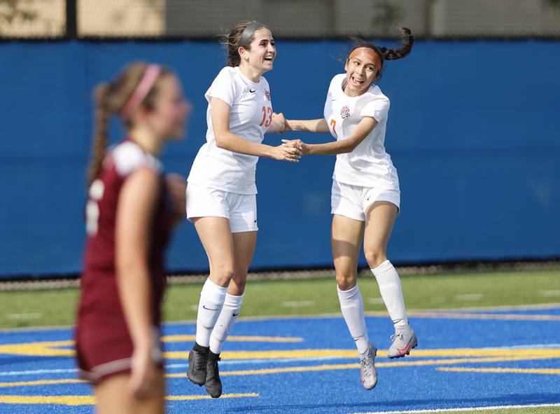 Crystal Lake Central's Jordin Gaunaurd (13) and Jenice Hernandez (7) celebrate a goal against St. Ignatius during the 2A girl's varsity supersectional soccer match between Crystal Lake South and St. Ignatius high schools on Tuesday, June 3, 2025 in Chicago.