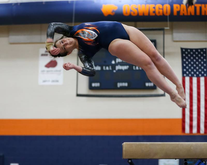 Oswego's Kelsie Freundt dismounts off of the balance beam during Oswego Gymnastics Regional. Feb 7, 2022.