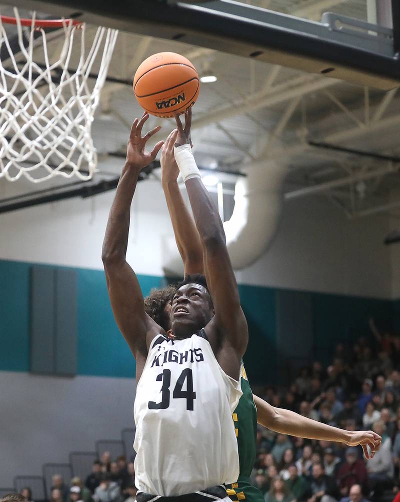 Kaneland’s Jeffery Hassan grabs a rebound in front of Crystal Lake South's Noah Cook during the IHSA Class 3A Woodstock North Sectional final basketball game on Friday, March 6, 2026, at Woodstock North High School.