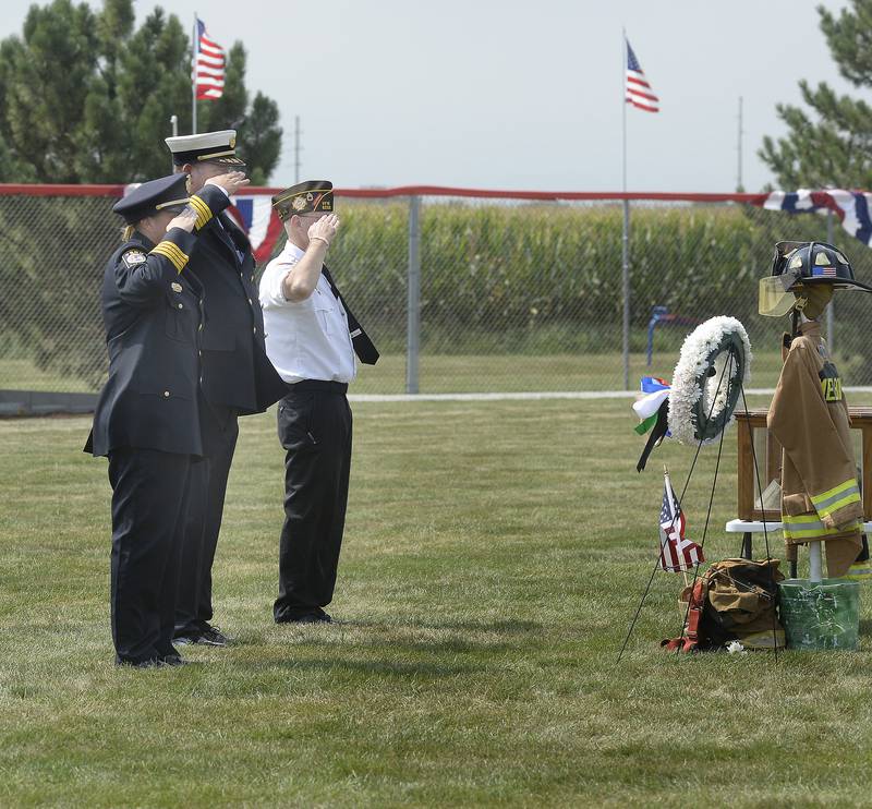 After a wreath laying, an honor guard salutes first responders at the 9/11 First Responders Wall on Saturday, Aug. 26, 2023, at Veterans Memorial Park in Peru prior to a ceremony honoring those memorialized on the wall.