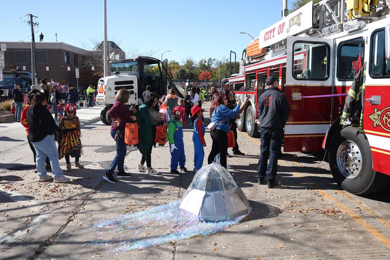 A line forms to sit in the fire engine at the Joliet Police Department Trunk-Or-Treat event on Saturday, Oct. 26, 2024 in Joliet.