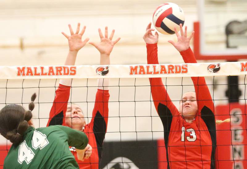 Henry-Senachwine's Grace Anderson blocks a spike with her fingertips from St. Bede's Hanna Waszowiak on Tuesday, Oct. 21, 2025 at Henry-Senachwine High School.