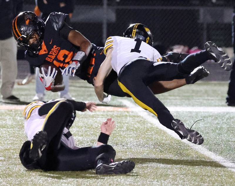 DeKalb's Derrion Straughter dives for extra yardage as he is brought down by Andrew’s Danny Moss during their game Friday, Oct. 16, 2025, at DeKalb High School.