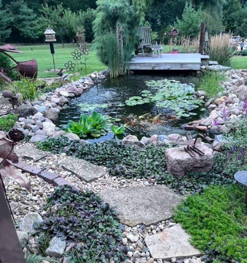 Bill and Cheri Schmitt’s garden features a koi and goldfish pond as well as a large, natural swimming pond that includes a waterfall surrounded by boulders.