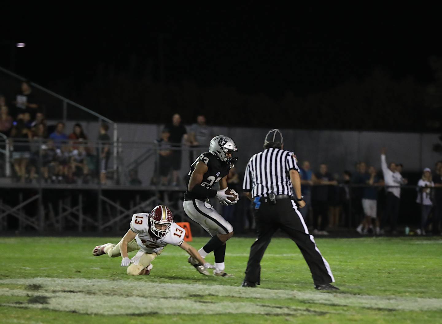 Kaneland's Aric Johnson hauls in a pass Friday that he turned into an 82-yard touchdown in a 49-35 loss to Morris.