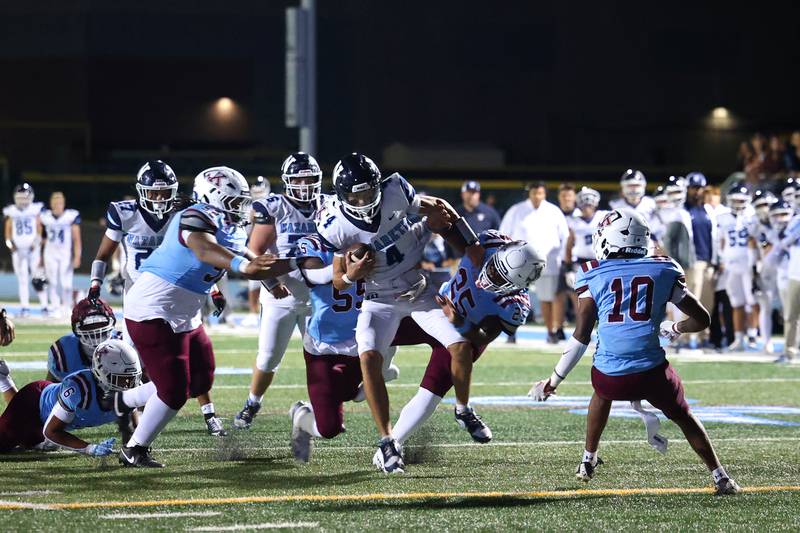 Nazareth's Frankie Nichols runs the ball as Kankakee defenders slow him down during Kankakee's 33-12 loss to Nazareth on Friday, Aug. 29, 2025.