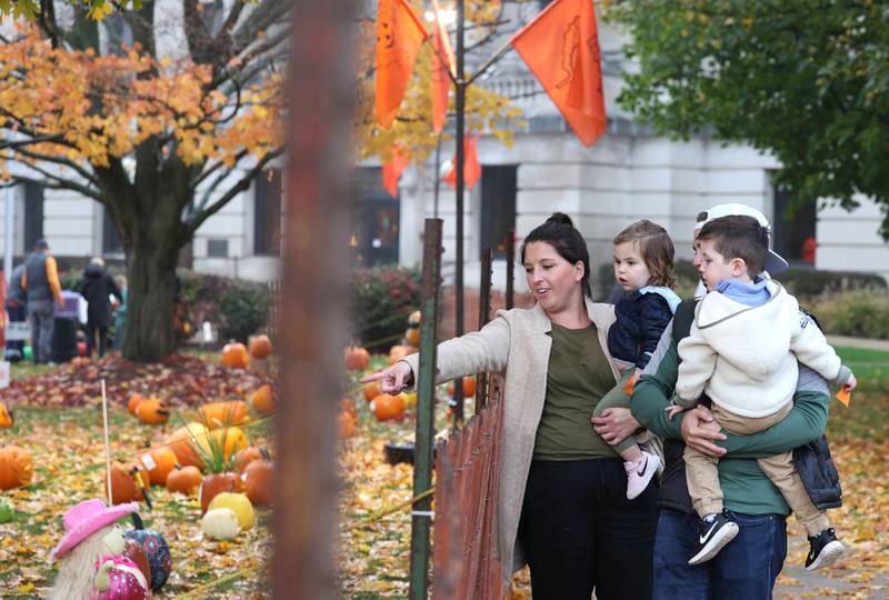 Visitors check out the pumpkins Wednesday, Oct. 25, 2023, on the lawn of the DeKalb County Courthouse during the Sycamore Pumpkin Festival.
