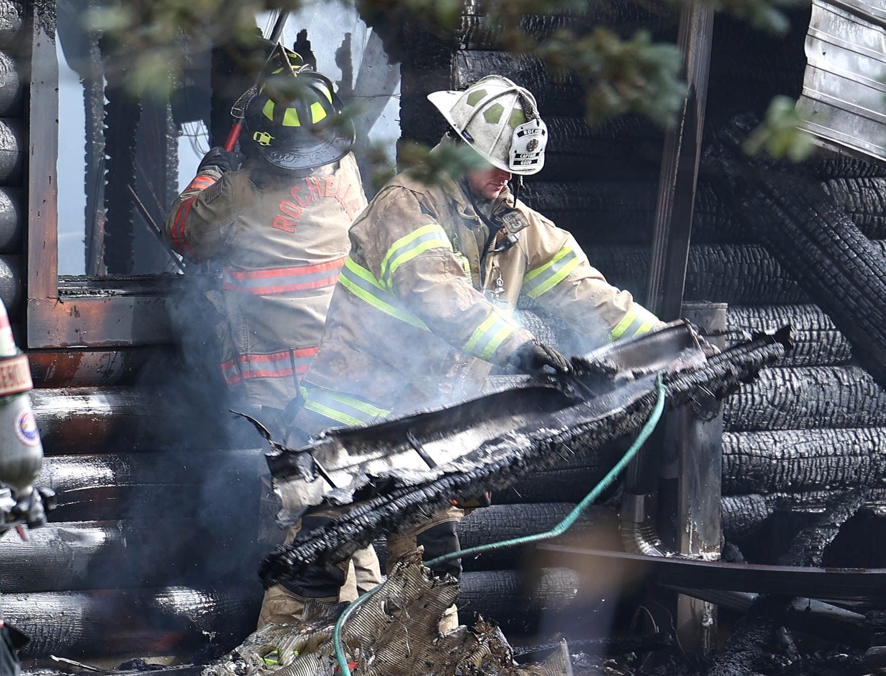 Rochelle firefighters pull debris from a house that was destroyed by fire Thursday, Nov. 13, 2025, near Shabbona Grove Road in Shabbona. Several local departments responded to the general alarm structure fire.