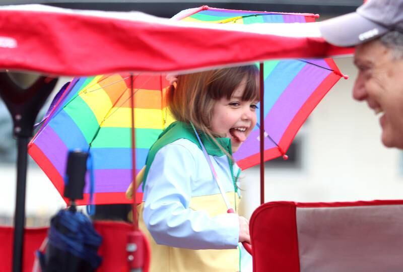 Kalani Nickolas, 4, of Woodstock, prances in the rain during the farmers market Saturday, April 29, 2023, on the historic Woodstock Square.