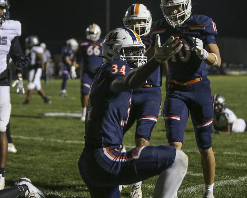 Oswego's Ammar Banire (34) reacts after scoring his first touchdown during football game between Oswego East at Oswego Friday, Oct 17, 2025 in Oswego.