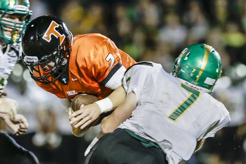 Crystal Lake Central quarterback Kyle Lavand is tackled by Chris Ivers of Crystal Lake South during a game at Central High School in Crystal Lake, Ill. on Friday, September 6, 2013. south defeated Central 14-7.